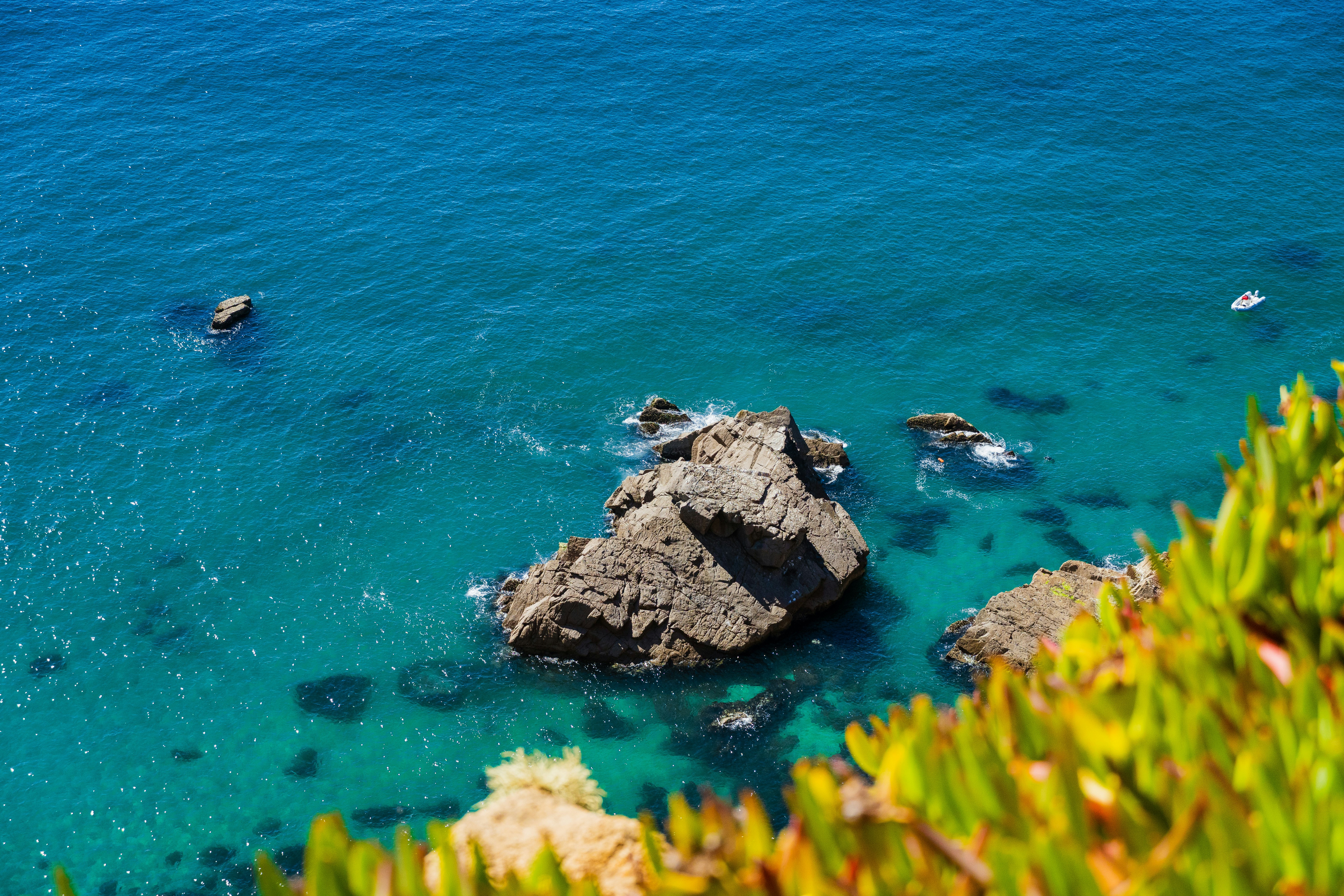 grey rock islet near shore